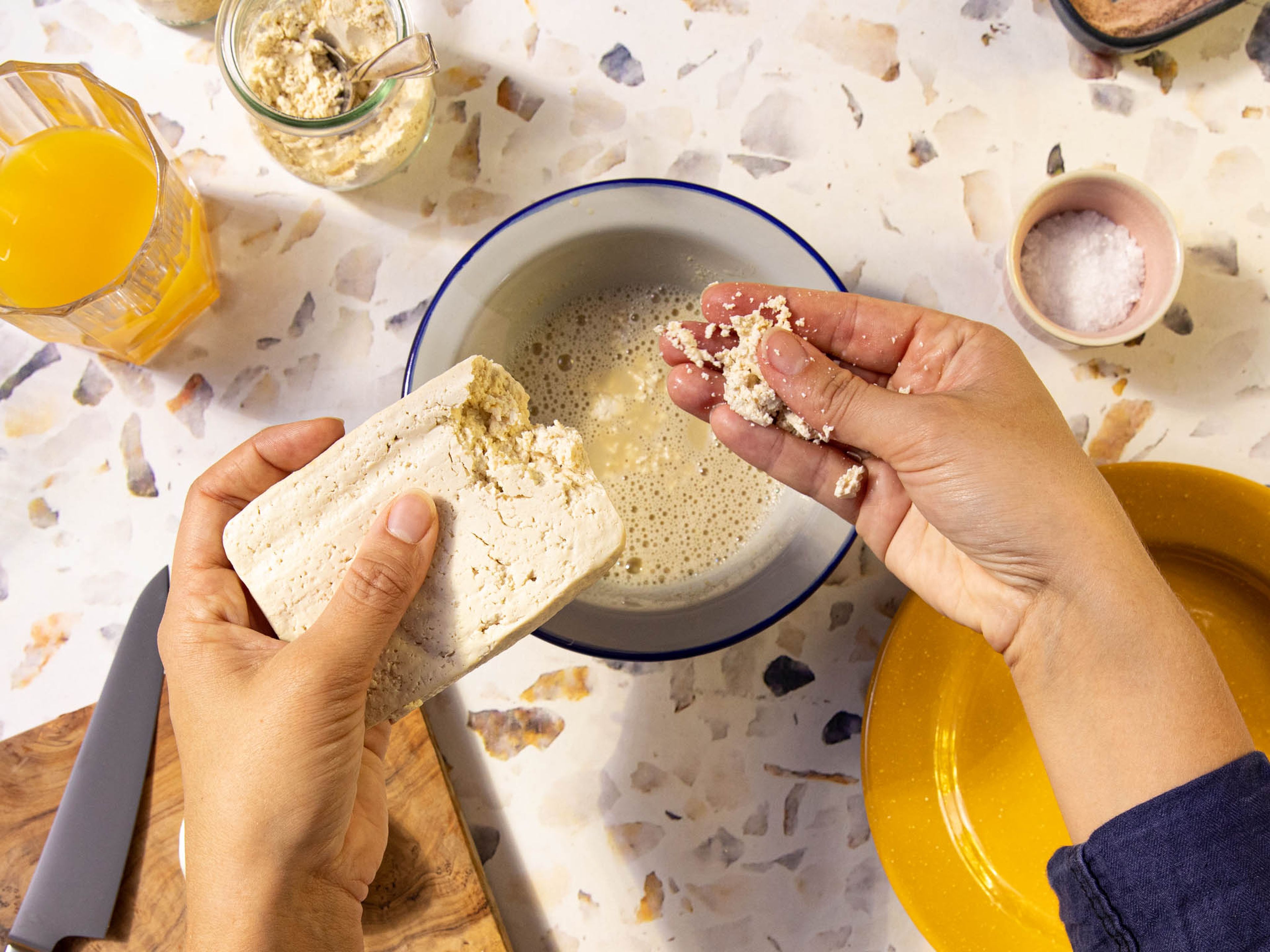Crumble tofu into the bowl with your hands and season with salt and pepper.