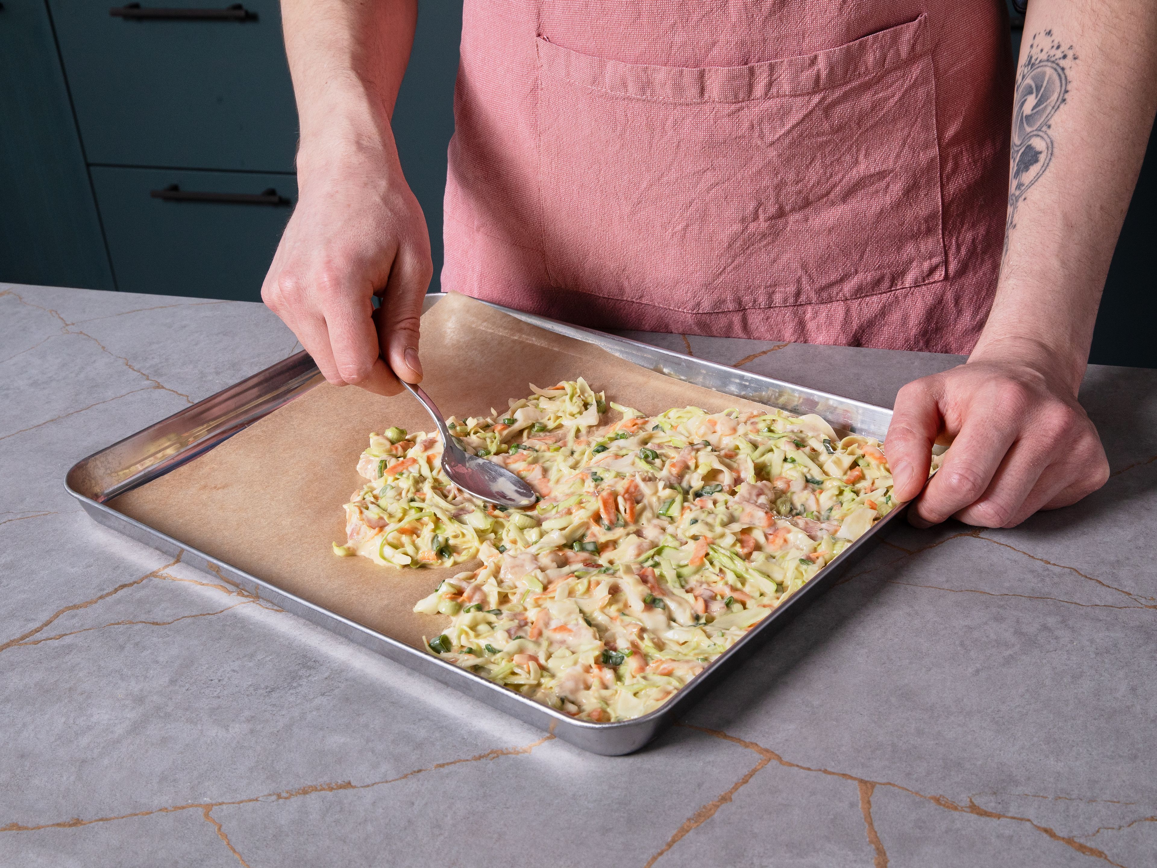 Carefully remove the hot baking tray from the oven and reduce the temperature to 220°C/430°F. Generously add oil to the tray and tilt to coat the whole surface. Pour in the batter and spread evenly. Bake Okonomiyaki for approx. 15 min., until the bacon is cooked through and the edges turn golden brown.