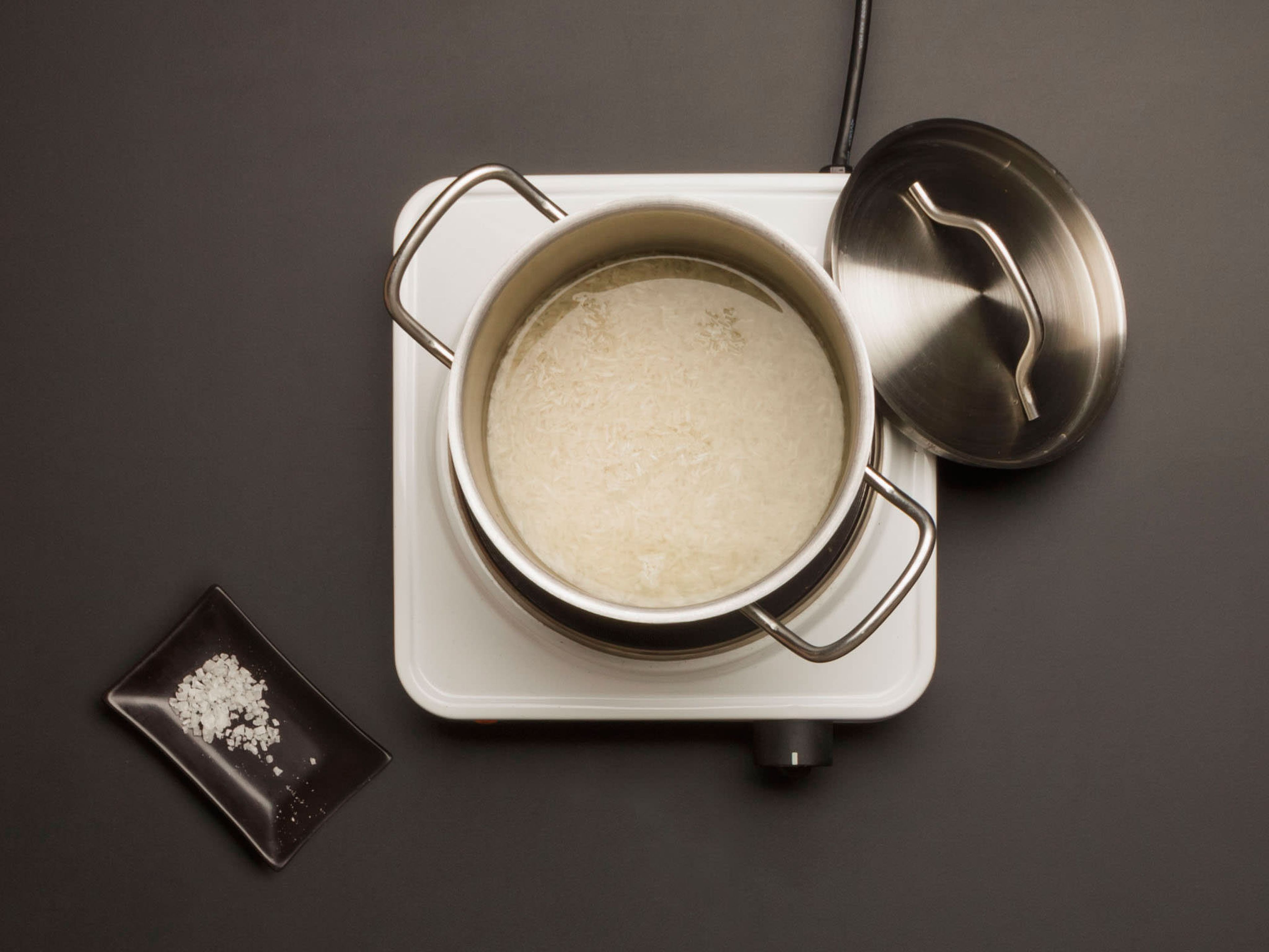 In a separate large saucepan, add rice, water, and salt. Bring to a boil, cover, reduce heat to low, and cook for approx. 12 – 14 min. until rice is tender and has absorbed all the liquid.