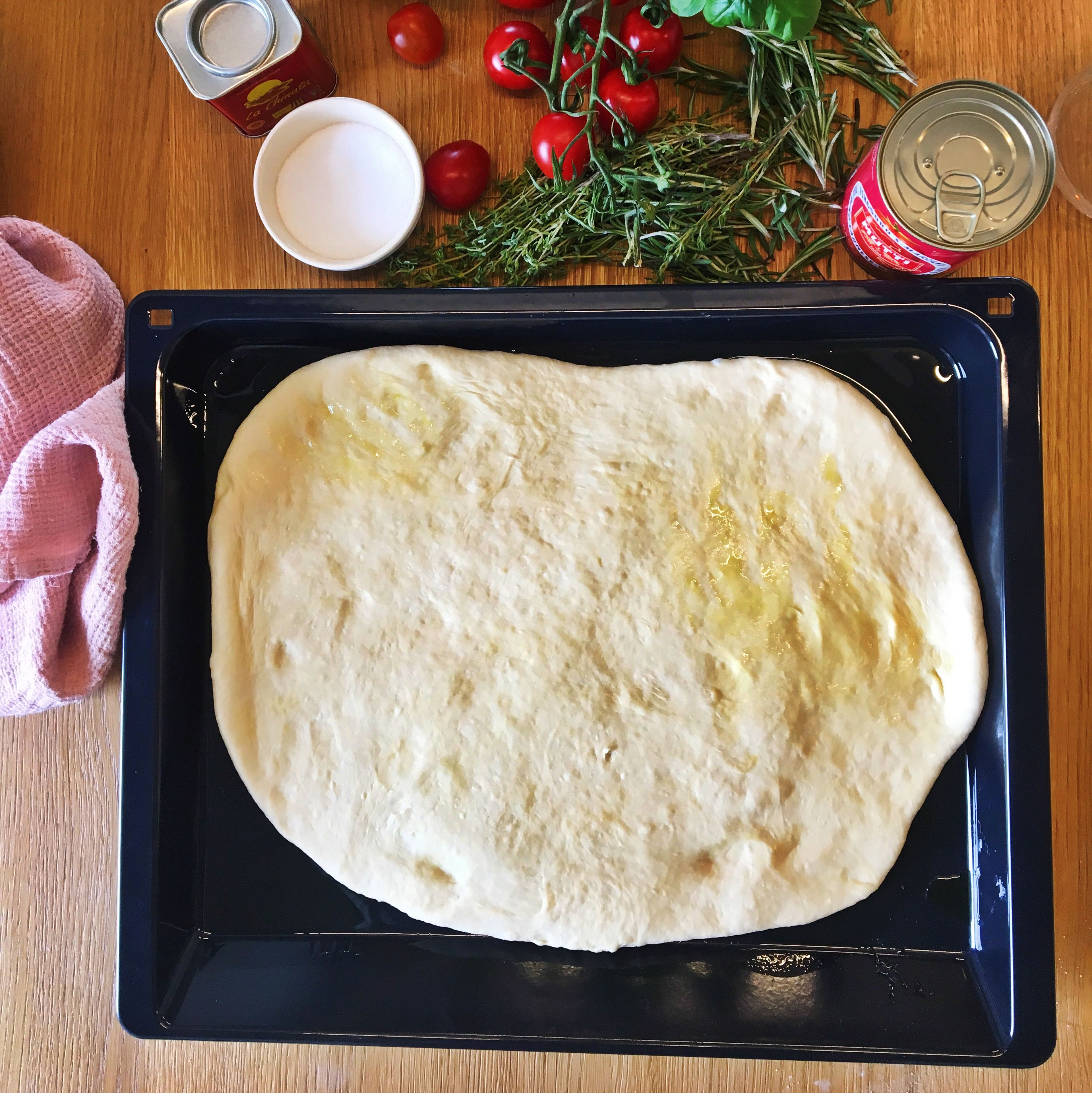 Grease a baking sheet with olive oil and carefully transfer the dough to the baking sheet.