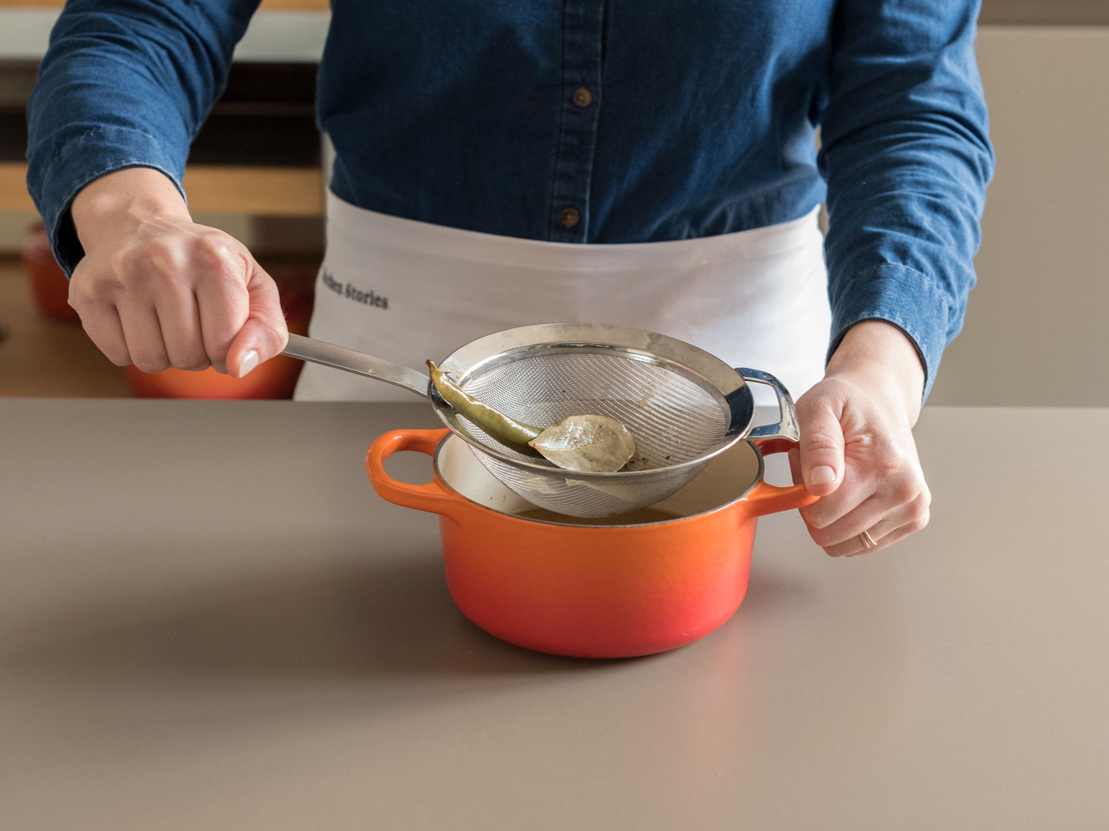Strain juices from slow cooker into small saucepan; discard solids.