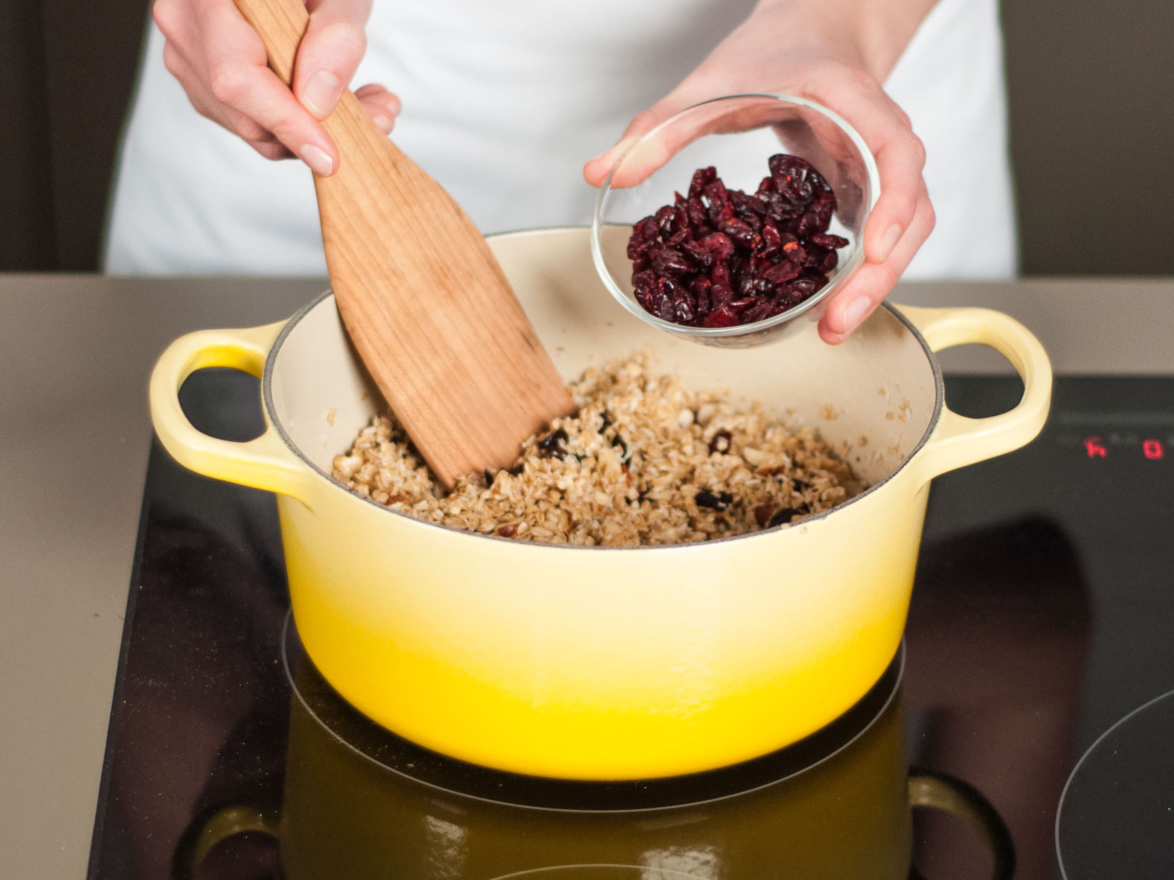 Add oats, coconut, chopped nuts, dried fruit, and cranberries. Stir thoroughly to combine.