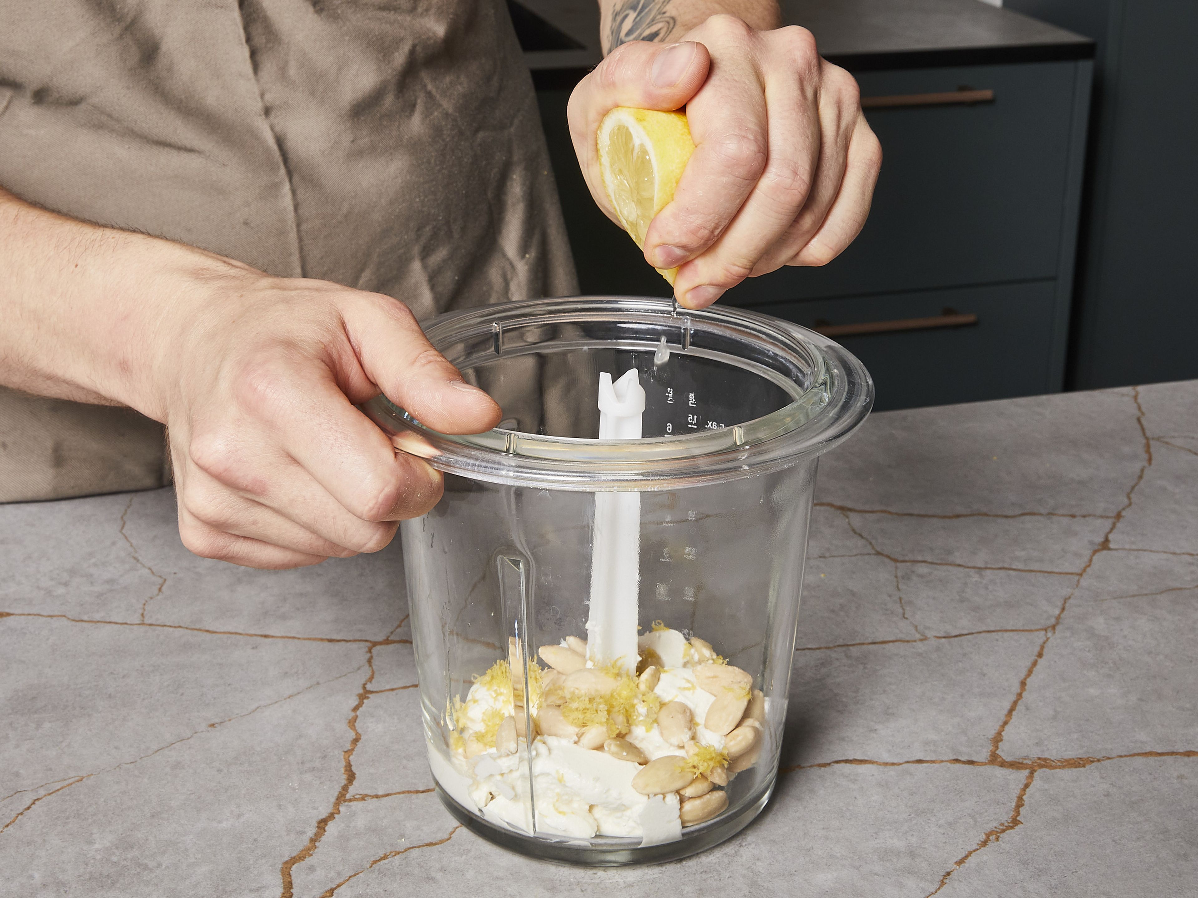 For the basil ricotta dip, finely chop basil. Put ricotta and almonds in a blender. Grate some lemon zest, cut lemon in half and squeeze the juice, then add both to the ricotta mix. Blend everything in a standing or immersion blender. Fold in chopped basil and the remaining olive oil. Season with salt and pepper and set aside.