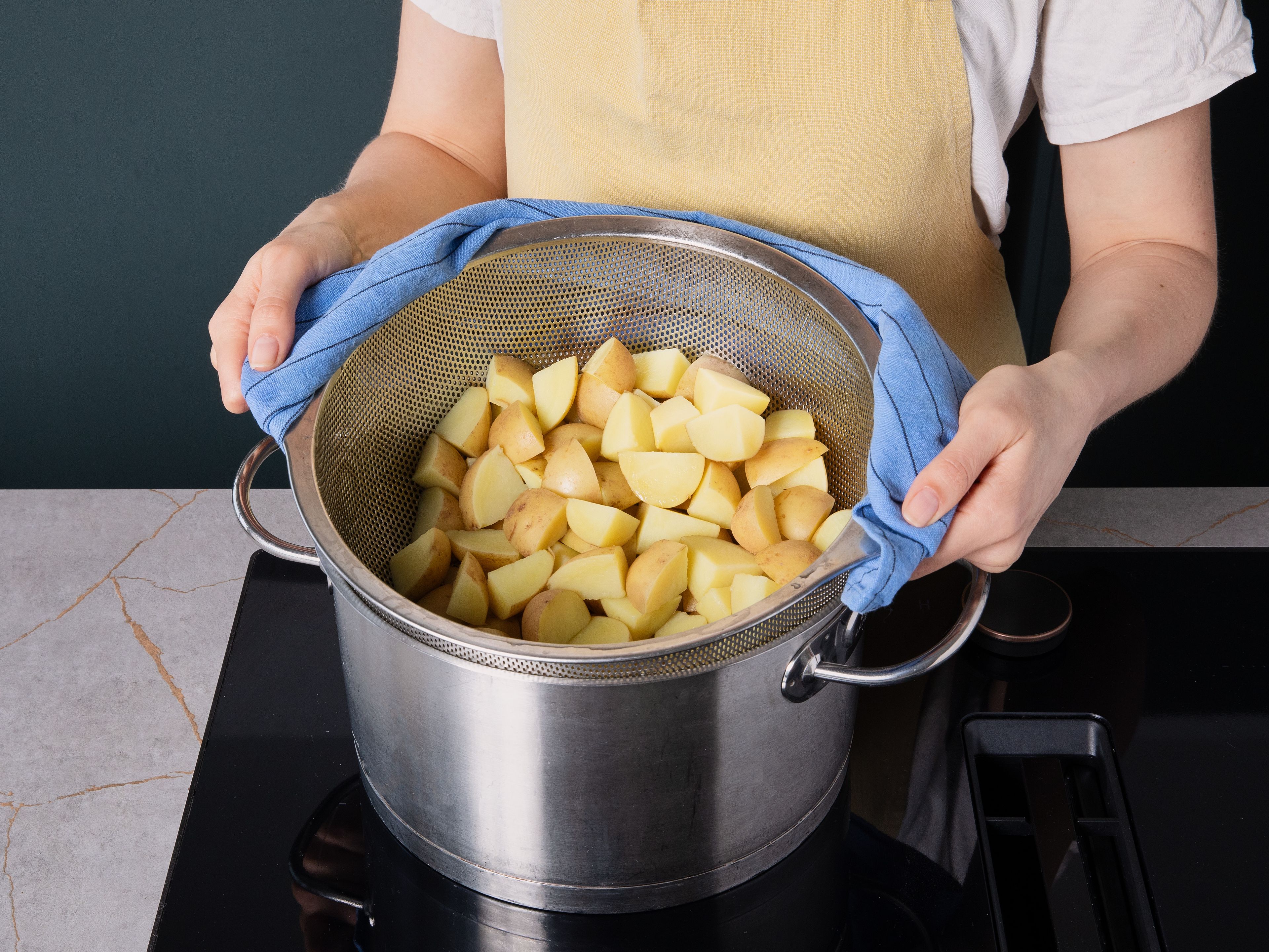 Halve or quarter potatoes depending on size. Add to a pot, cover with salted water, bring to a boil, and simmer for approx. 15 min., until cooked but still firm to the bite. Drain and let cool slightly.