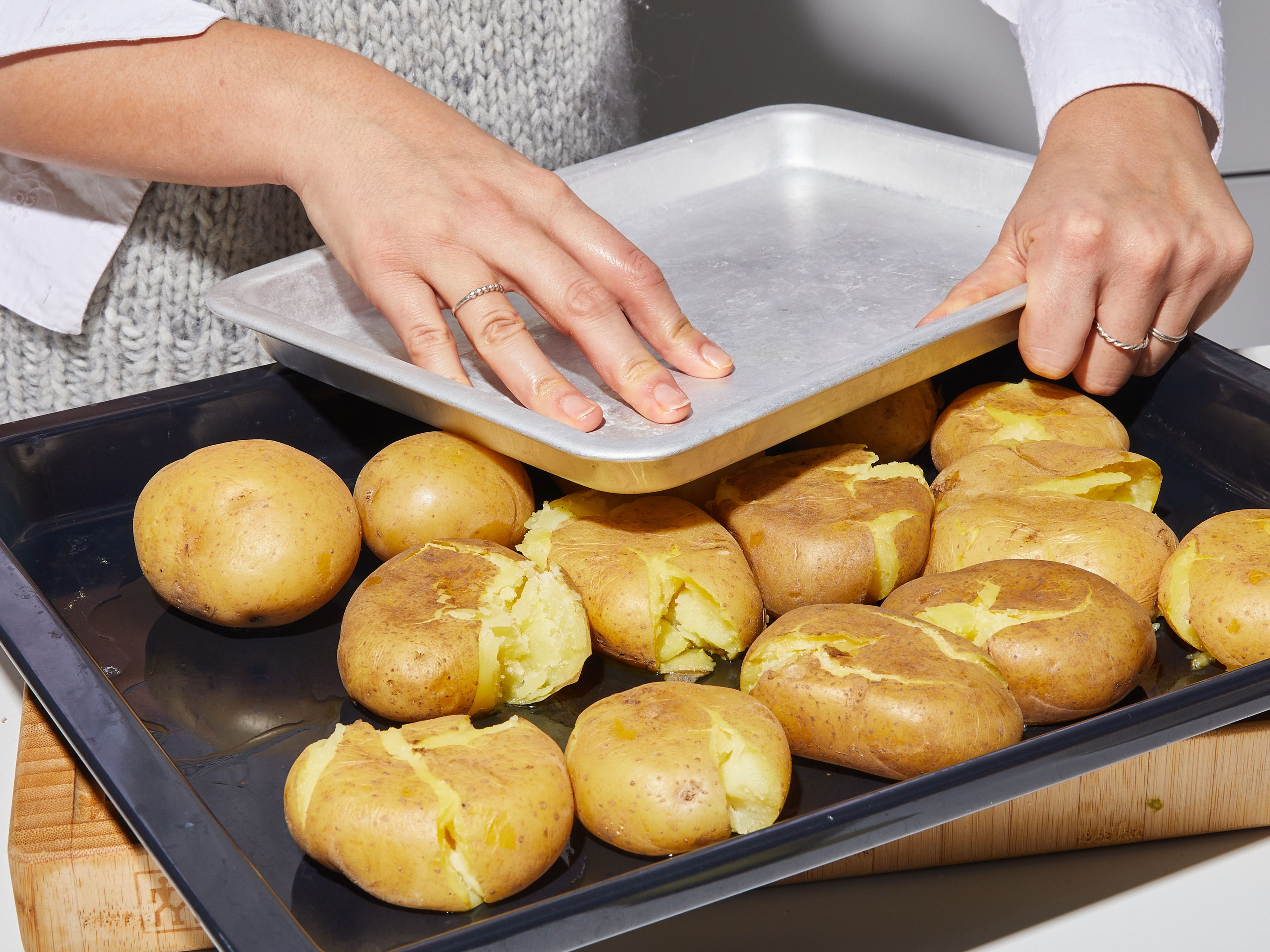 To ‘smash’ the potatoes, place either another baking sheet or a dinner plate on top of the potatoes and press down to squash them. Drizzle liberally with olive oil and season with flaky sea salt. Transfer the baking sheet to the oven and bake approx 30 min., or until very golden and crispy.