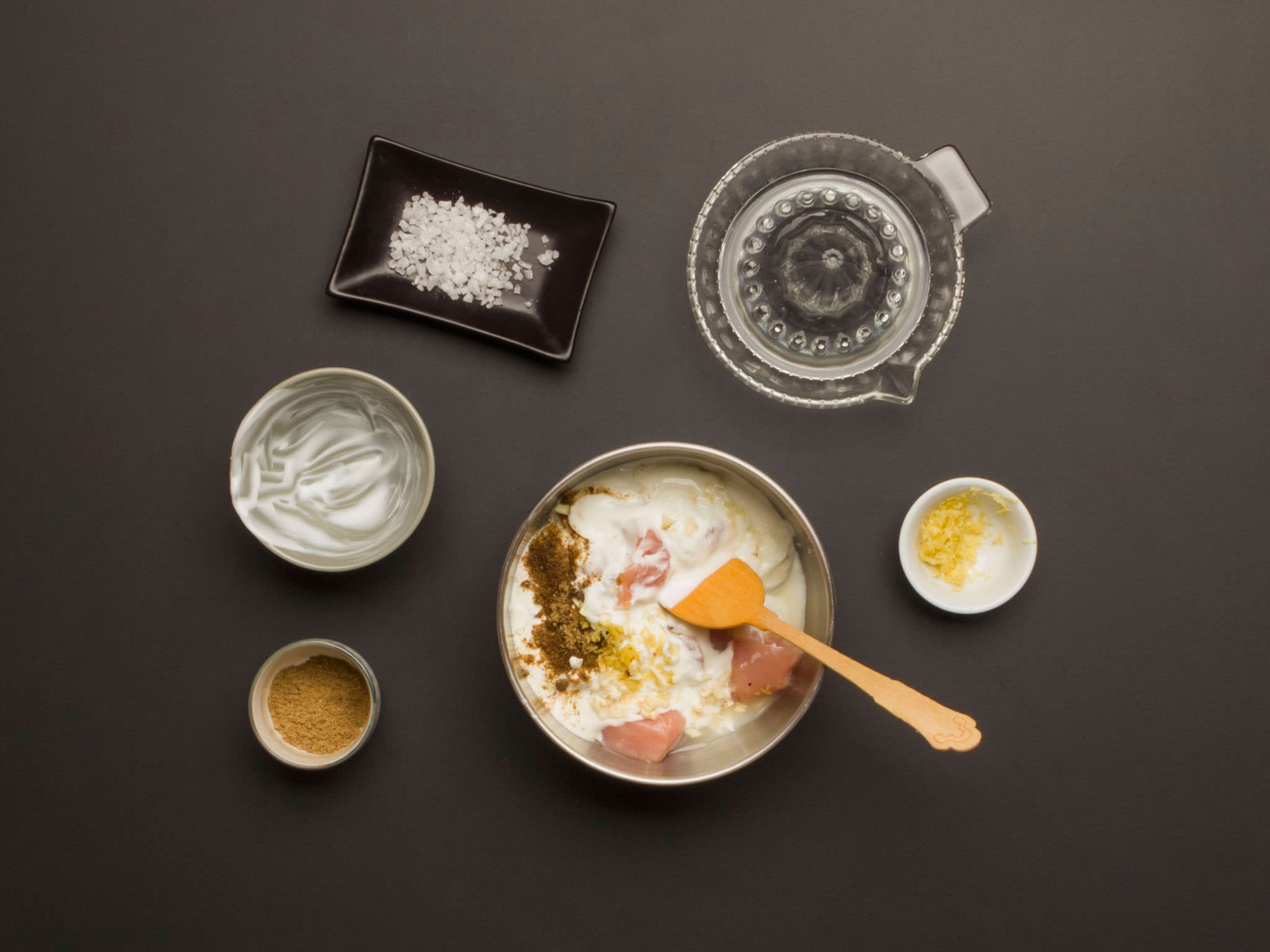 In a large mixing bowl, mix together chicken, yogurt, ginger, half of the garlic, half of the garam masala, lemon juice and zest, and some salt.