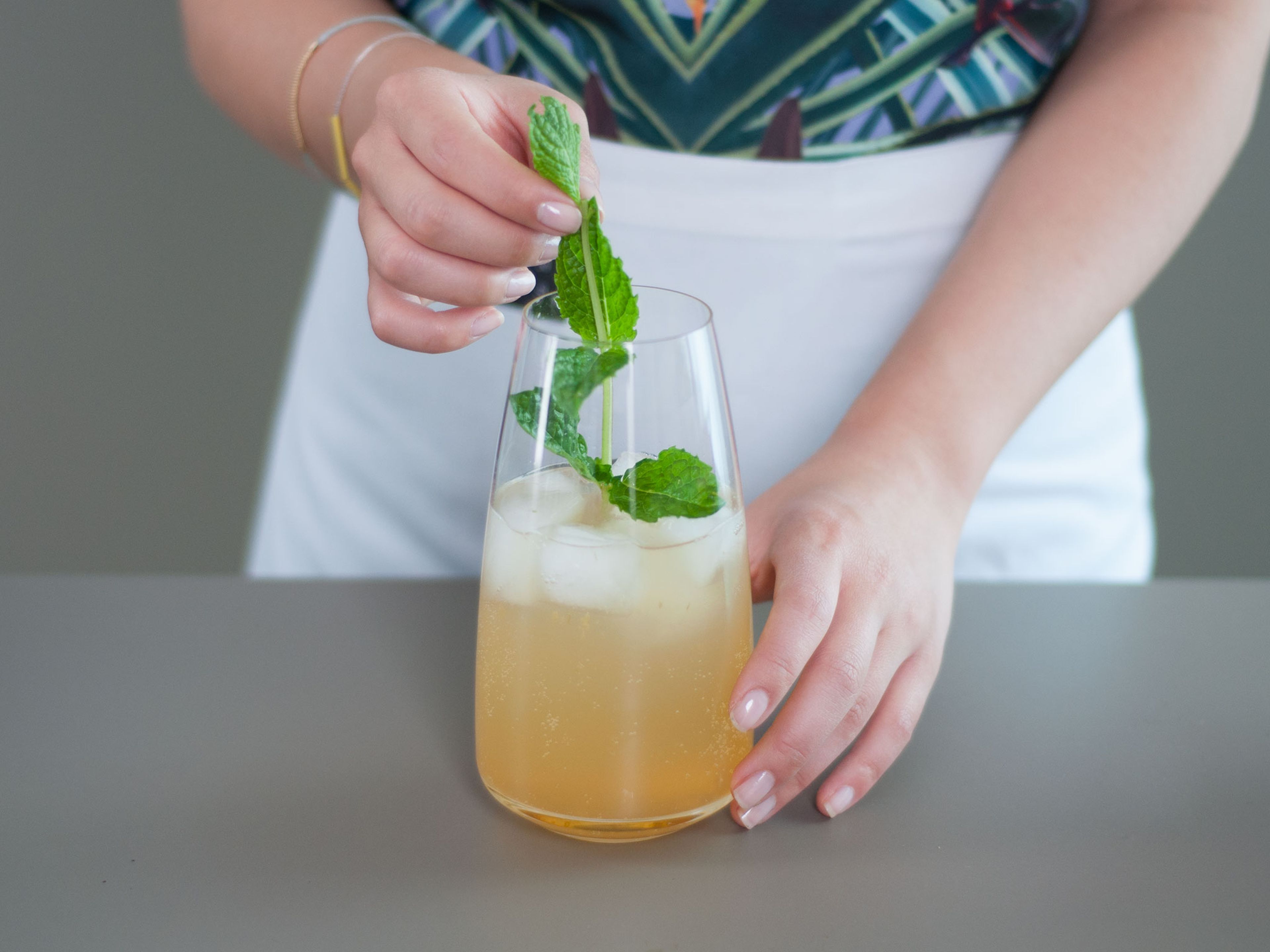 Fill glasses with ice. Fill three-quarters full with sparkling water. Add two to three spoons of syrup and stir.
