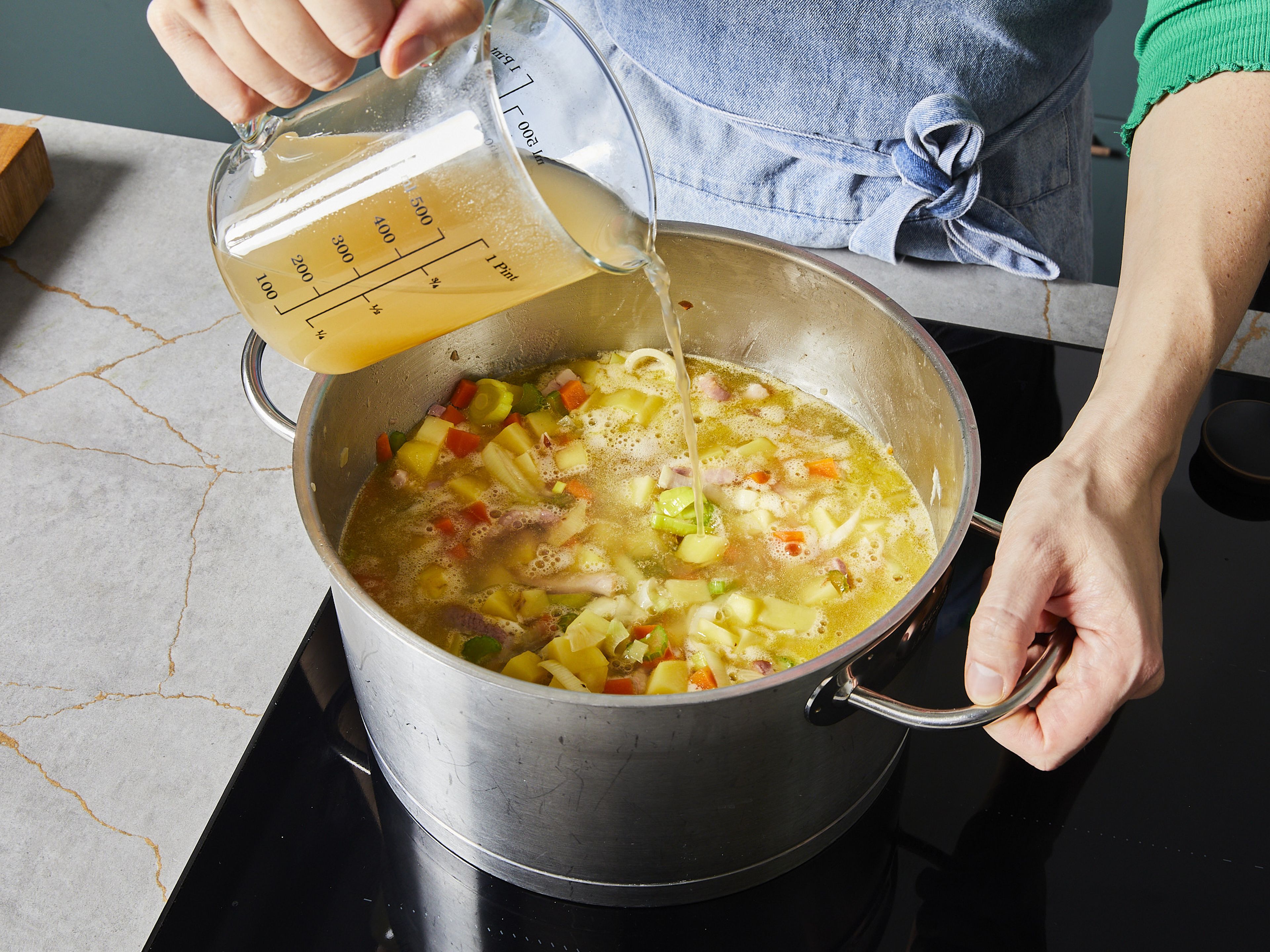 Put bacon in a pot with some hot oil, add chopped onion and sauté until onion is translucent. Add diced potatoes, carrots, leek and celery. Sauté for approx. 10 min. more, then deglaze with vegetable broth and water. Add marjoram and let cook for approx. 30 min.