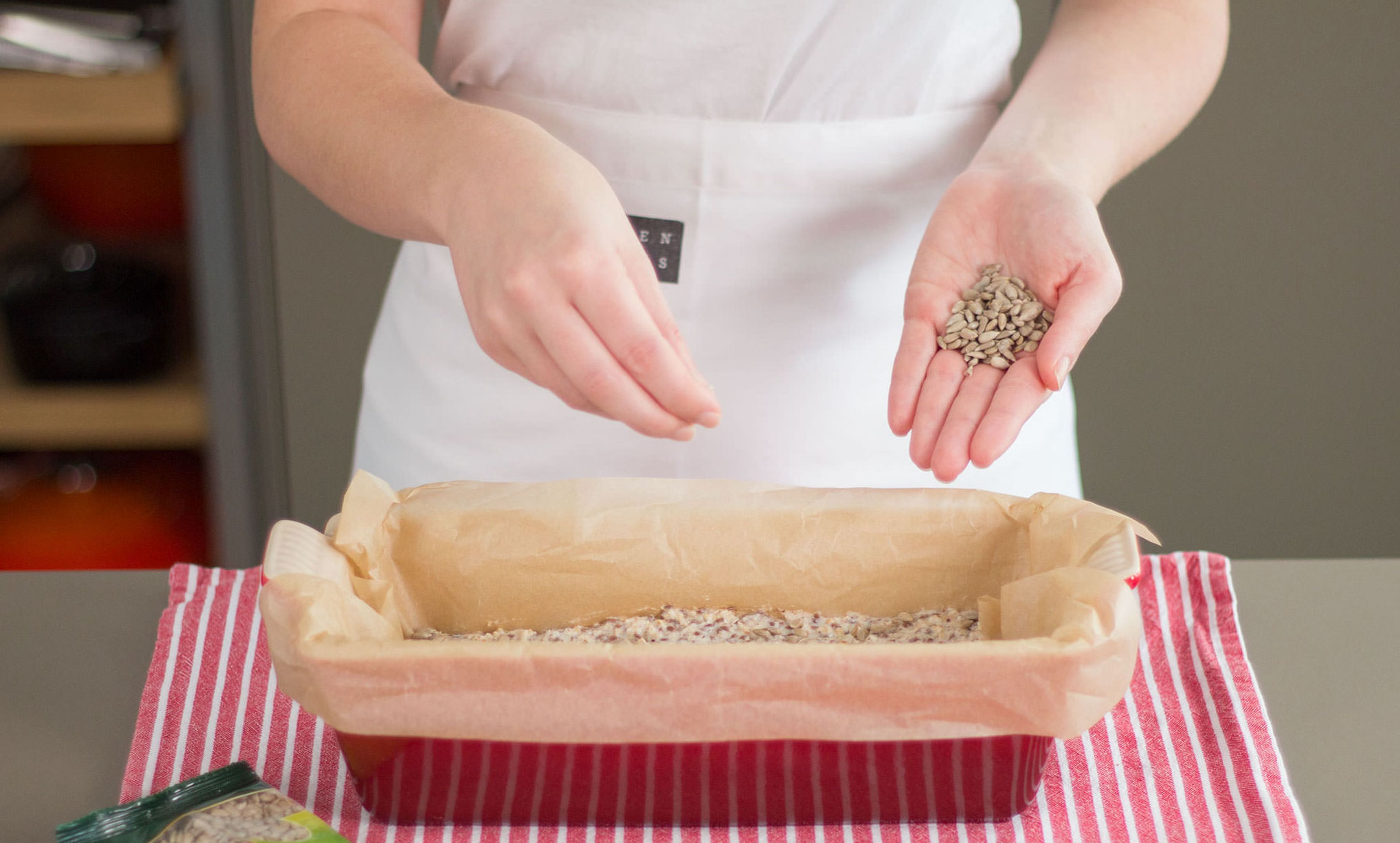 Transfer dough to a parchment-lined air fryer loaf pan. Sprinkle sunflower seeds on top. Bake in the air fryer at 160°C/320°F, for approx. 35–45 min. Halfway, check if it browns too quickly, and if so cover with aluminum foil and continue the baking time.