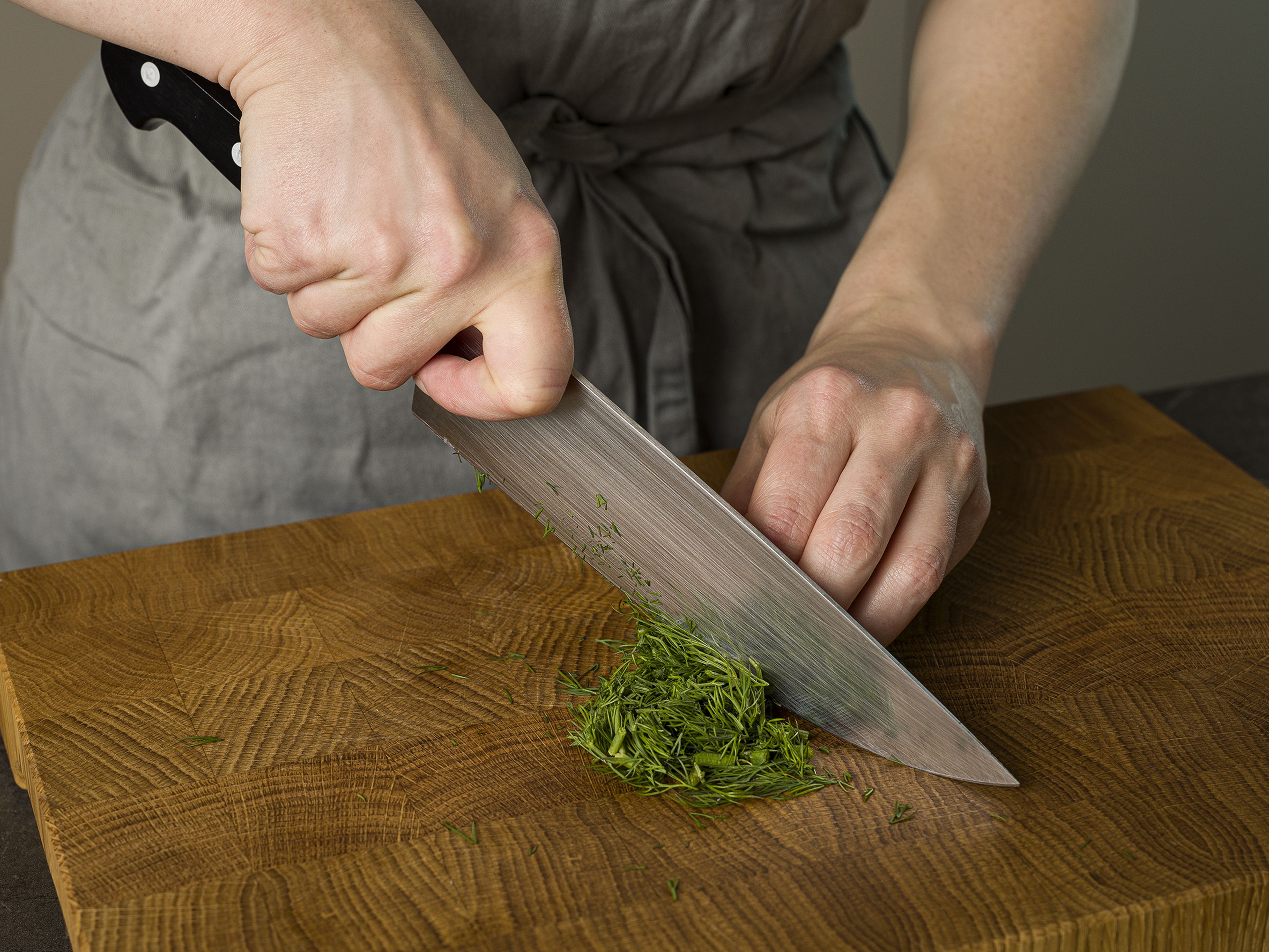 Take frozen spinach out and set it aside to defrost. Zest, halve, and juice lemon. Finely chop onion, and grate garlic. Chop dill. Drain and rinse chickpeas.