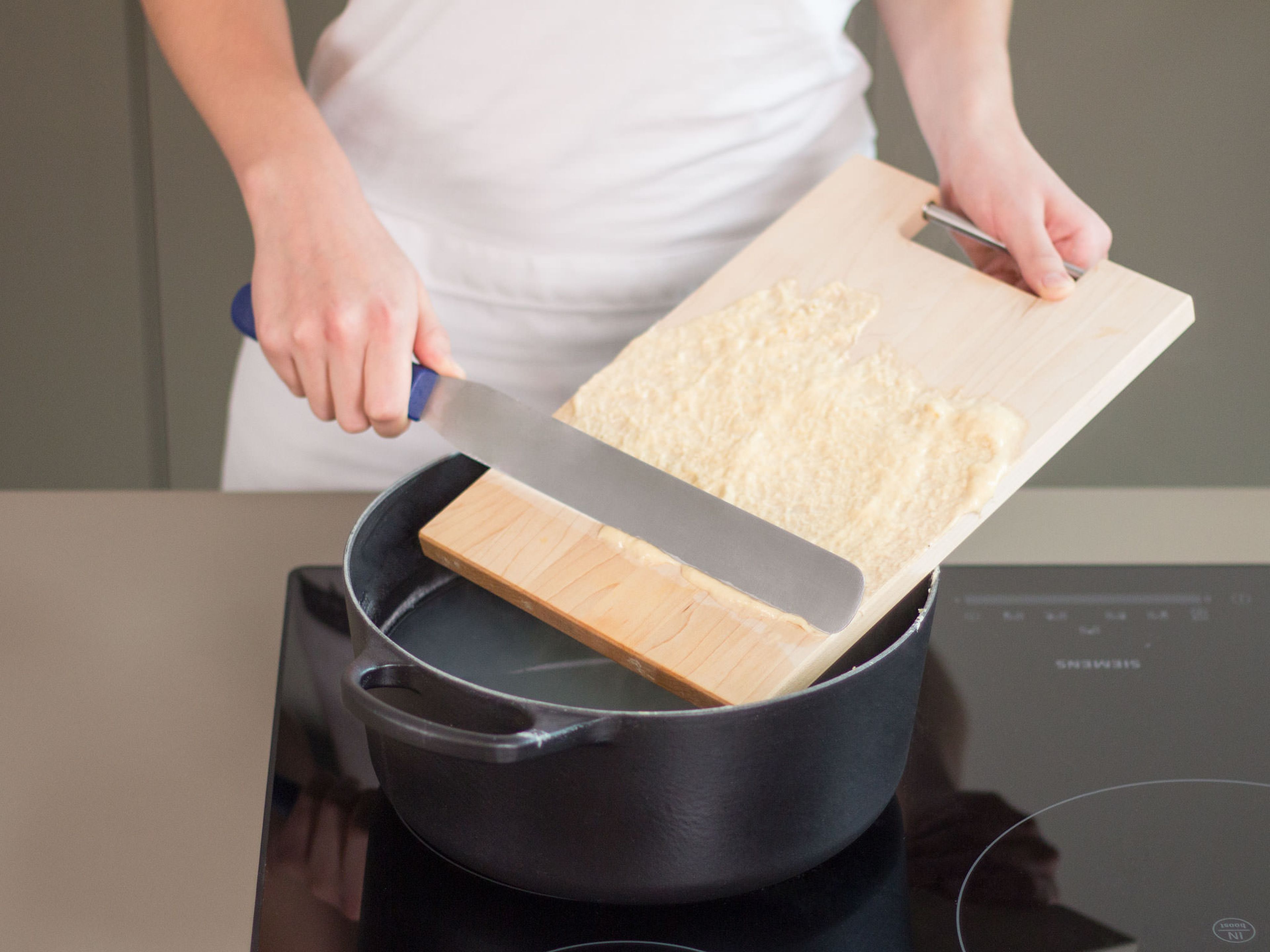 Fill a large saucepan half full with salted water and bring to a boil over medium-high heat. Next, wet cutting board with a little boiling water and then spread a thin, even layer of dough over a cutting board. Using a pastry spatula, shave off thin strips of dough, approx. the width of a pencil, into water. Cook for approx. 1 min. or until spätzle rises to the surface. Transfer to an ice bath for approx. 20 sec. to halt cooking process and then place in a colander to drain.