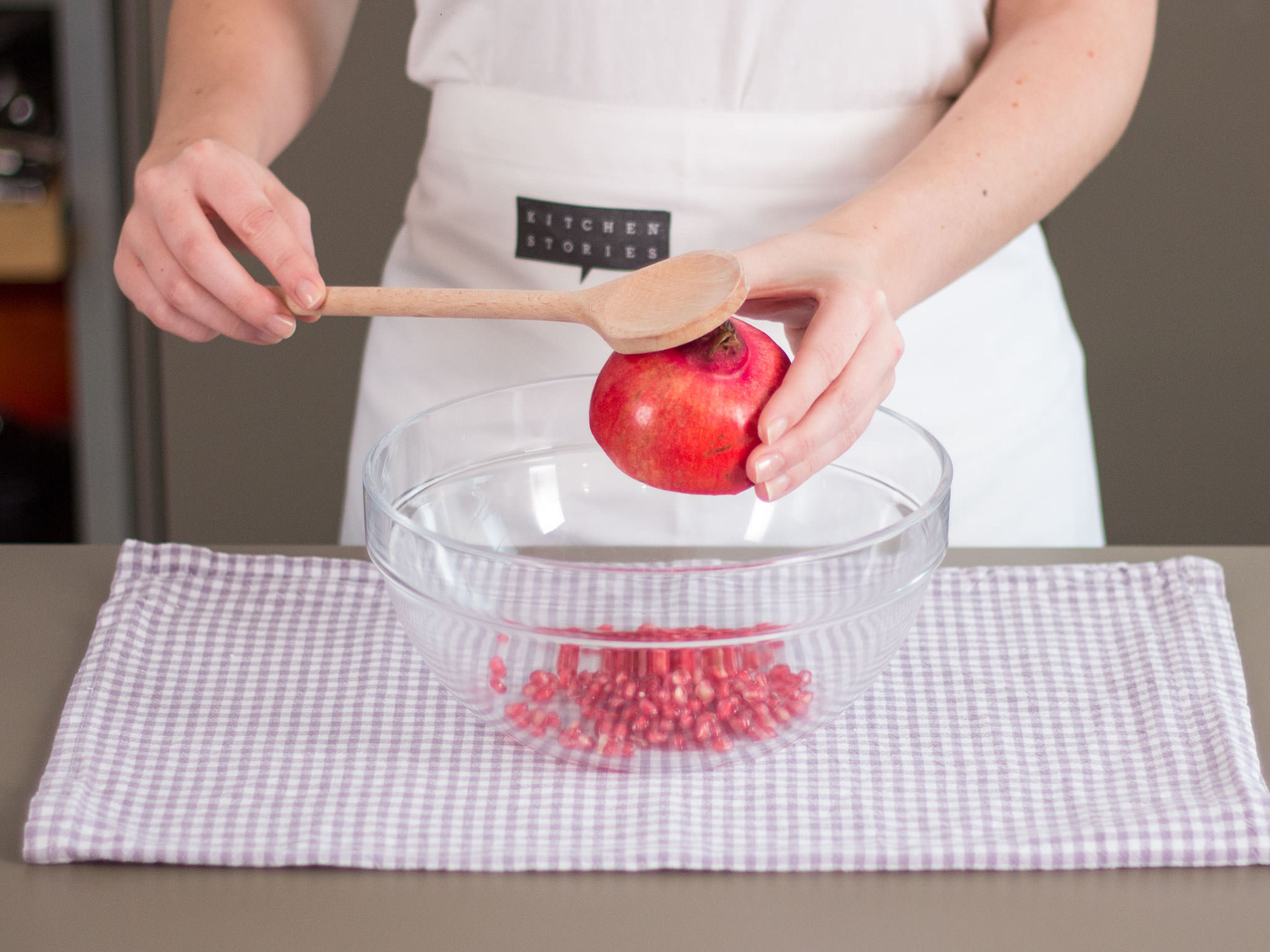 Cut pomegranate in half and deseed.